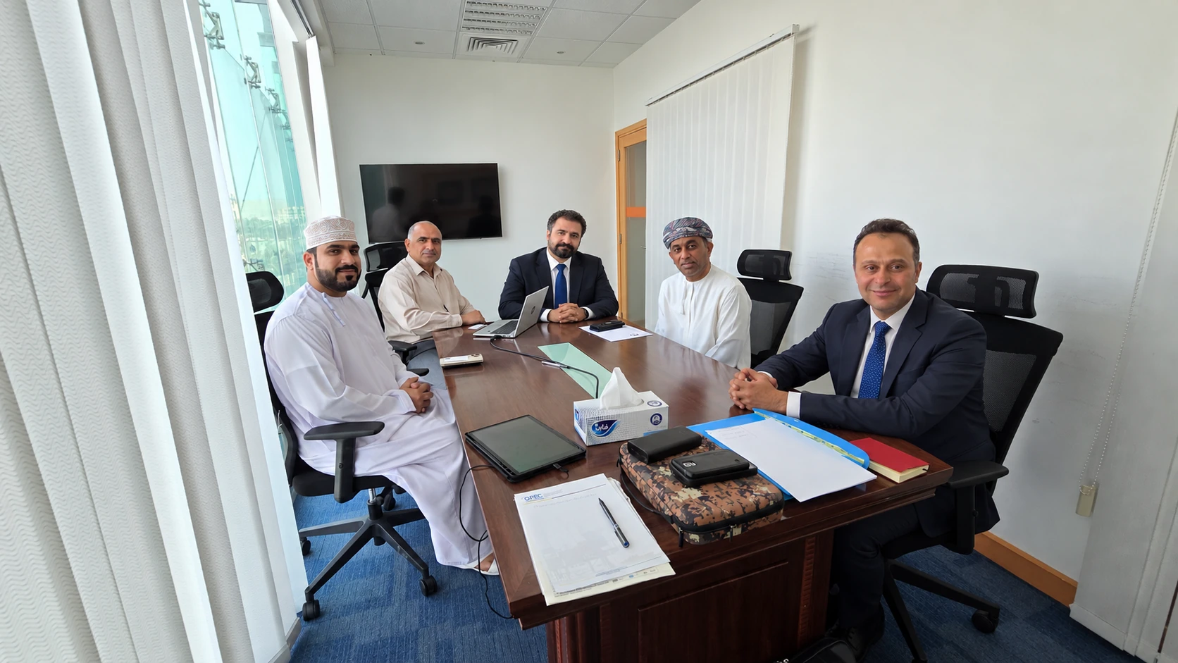 Edited composite illustration of a professional business meeting in Oman